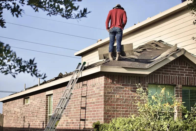 Professional roofer working on a residential roof in Skyway